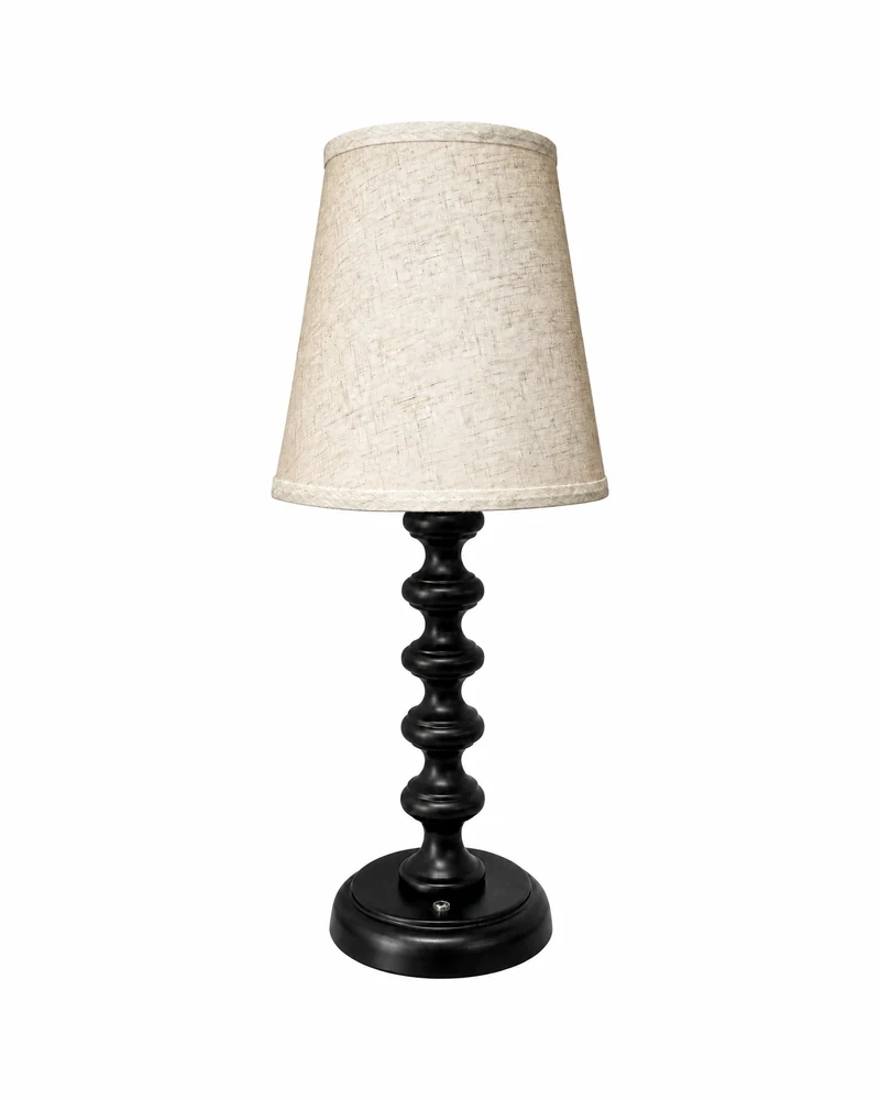 Table lamp with a black stacked-bead column and a cream fabric shade